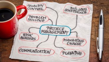napkin with words about project management written on it