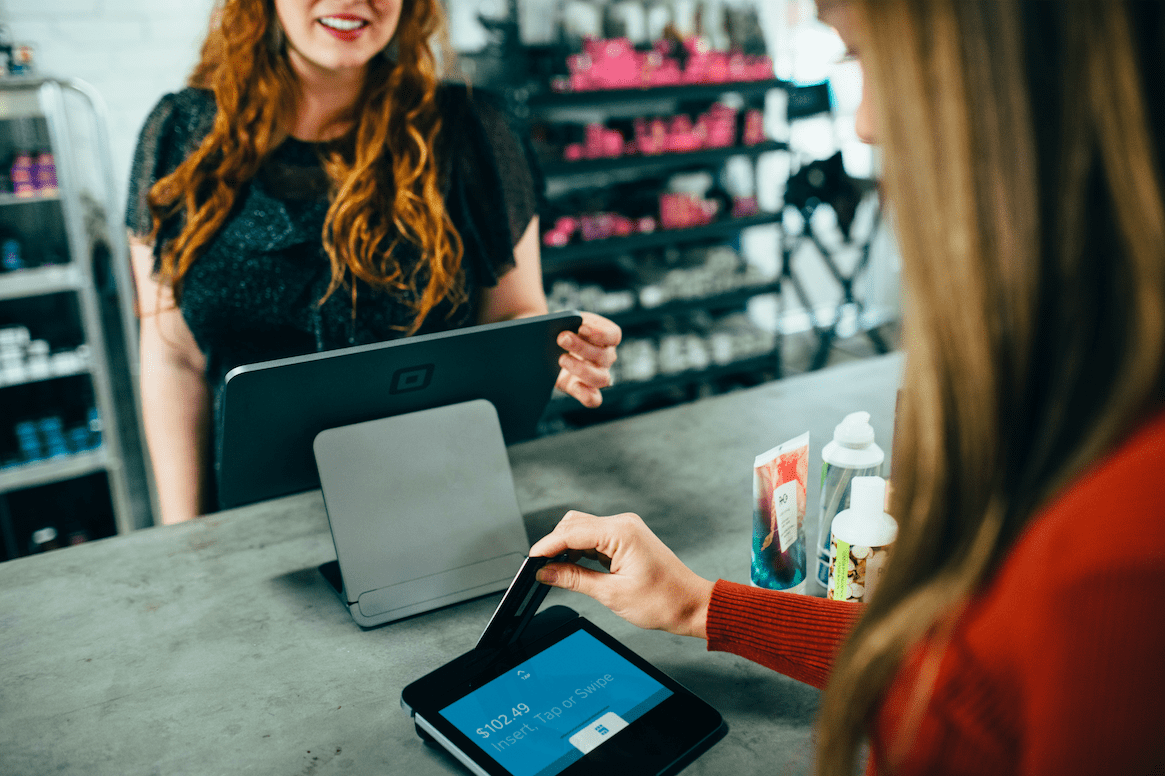 one individual swiping their credit card as a result of focusing on customer experience through digital transformation